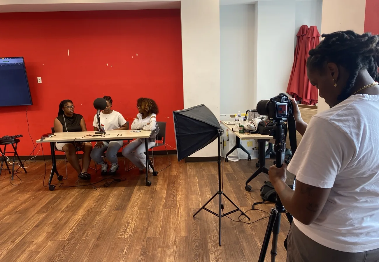 Youth producing multimedia content with cameras and recording equipment during Crowns programming.