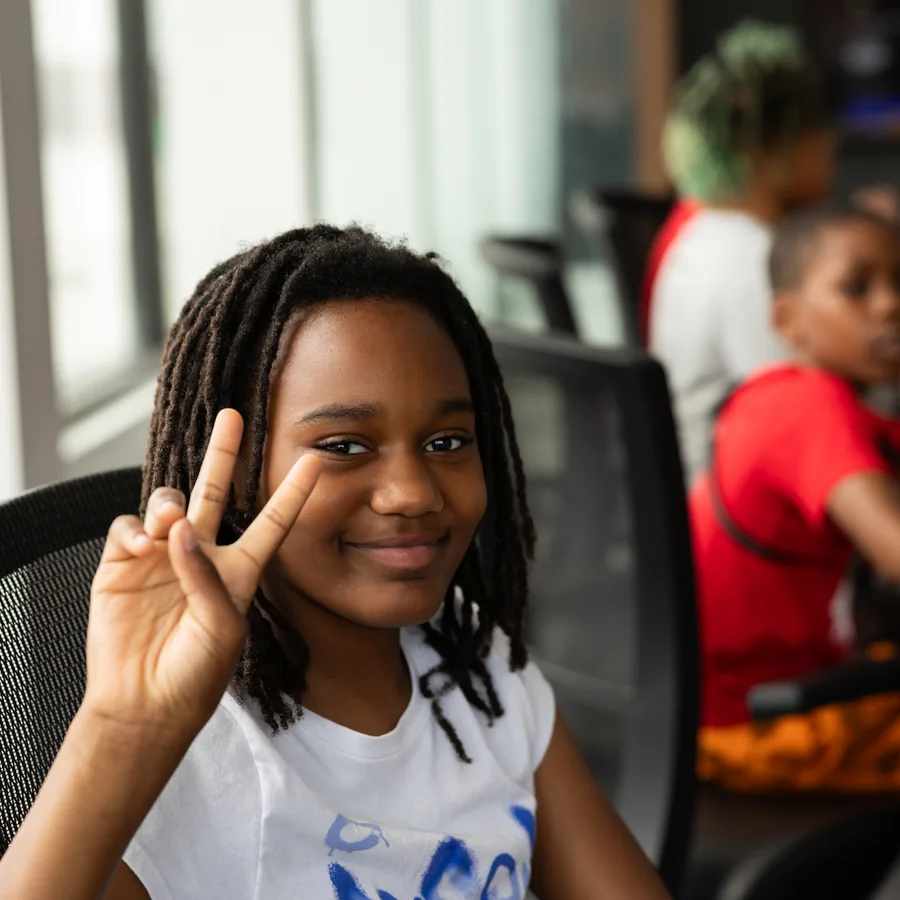 A young participant smiling during a Crowns youth program.